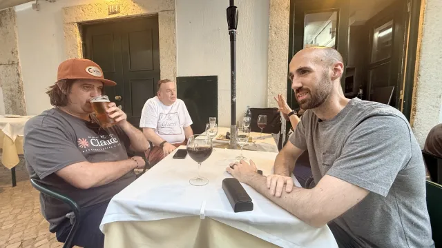 Two people talking over a glass of wine at dinner