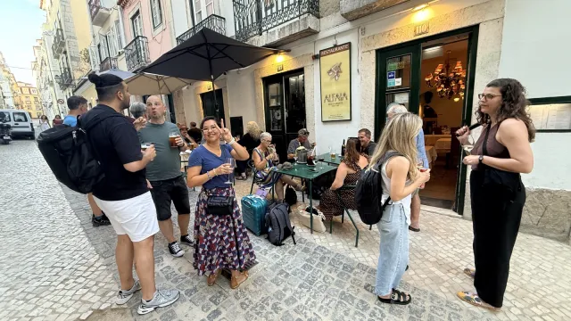 People chatting with drinks outside the restaurant before dinner